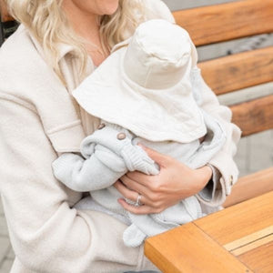 baby wearing the mobobaby sunhat and nursing cover in natural